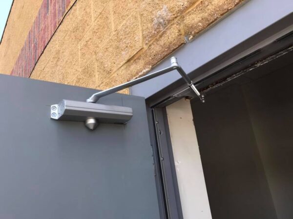 spring door closer on a steel commercial door spring door closer mounted on a steel commercial door