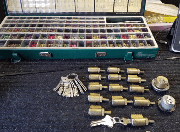 A diverse array of rekey interchangeable cores are displayed along with various pins for rekeying a lock.