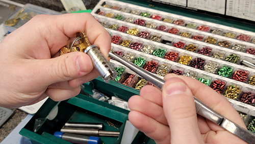 Locksmith replacing the pins in a lock cylinder Locksmith replacing the pins in a lock cylinder